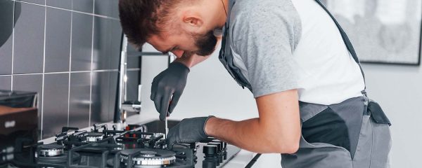 young-professional-plumber-in-grey-uniform-working-resize.jpg